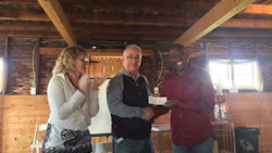 Tom Bissonnette of Parr Auto Body and former Chairman of CCIF (centre) with Marc and Lisa Honorat, founders of Haiti ARISE. The organization is raising funds to add collision repair training to the skills offered at the Haiti ARISE Technical & Professional School.