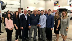 Stéphane Plante and his two sons at the Grand Opening event, accompanied by Fix Auto headquarters employees.
