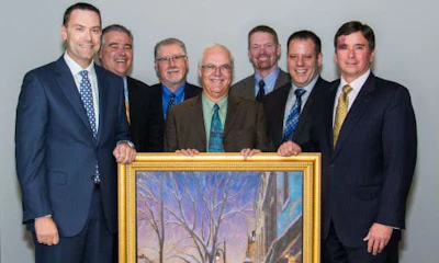 Axalta Coating Systems recently honoured its 60-year partnership with NAPA Canada at its Canadian headquarters in Montreal, Quebec. From left: Representing NAPA Canada, Alain Masse, President of UAP; Eric L&eacute;veill&eacute;, Vice President, CMAX and Paint & Body Supplies; Tom Hunt, Vice President, Product Development; Representing Axalta, Robert Searle, Refinish Product & Marketing Manager-Axalta Canada; Benoit Goulet, Regional Sales Manager, Quebec/Atlantic-Axalta Canada; Brent Jamieson, Axalta North America Sales Director; and Troy Weaver, Axalta Business Director pose with Axalta's gift to NAPA titled 'Winter Evening, St-Lawrence Boulevard' by Montreal artist Richard Montpetit. Photo by Eve Richard.