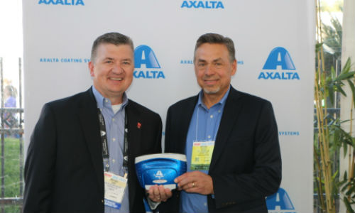 Mike Carr, Axalta's President &ndash; North America and Michael Gogoel, President of BYK-Gardner USA with a commemorative spectrophotometer painted with Brilliant Blue, Axalta&rsquo;s North American Automotive Color of the Year 2016.