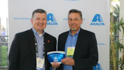 Mike Carr, Axalta's President – North America and Michael Gogoel, President of BYK-Gardner USA with a commemorative spectrophotometer painted with Brilliant Blue, Axalta’s North American Automotive Color of the Year 2016.