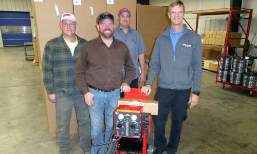 Freddy Smith (centre), collision repair instructor at Tennessee College of Applied Technology in Athens, Tennessee, receives a nitrogen plastic welder donation from Kurt Lammon (right), Terry Culpepper and Rob Dunston of Polyvance.