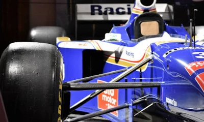 Villeneuve&rsquo;s 1997 Williams FW19 on display at the AutoShow. The car still bears the tire mark from where another driver tried to run him off the track.