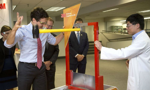 Prime Minister Justin Trudeau at 3M&rsquo;s Canadian headquarters, swinging a hammer at a new super-strong tape being developed as an alternative to rivets and fasteners.