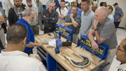 A Pro Spot staff member demonstrates the Pro Spot PR-5 Rivet Gun system, special dies and extension arms for the management team from Craftsman Collision.