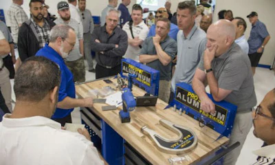 A Pro Spot staff member demonstrates the Pro Spot PR-5 Rivet Gun system, special dies and extension arms for the management team from Craftsman Collision.