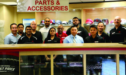 Cuong Phung (centre, shirt and tie) and team of parts specialists at Formula Honda.