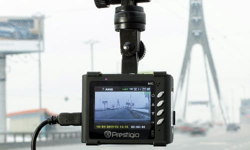 A dashboard camera on the inside of a vehicle&rsquo;s windshield.