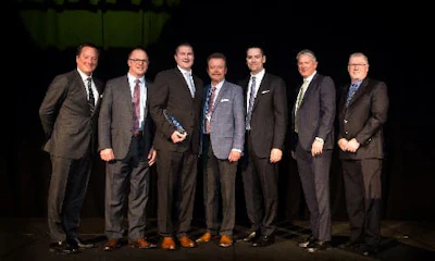 The BBB Industries team accepting their award.