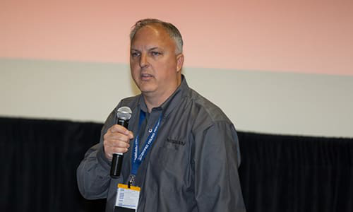 Mark Zoba speaks at a conference. Nissan has recently announced that it will add and improve partnerships between key industry people.