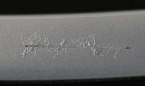 Filiform corrosion spreading from scribe on painted aluminum.