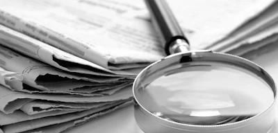 magnifying glass newspaper