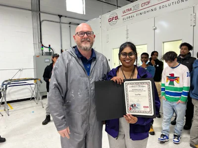 Sarah Mari poses with her brand new spray gun after being named SATA’s student with the most painting promise.