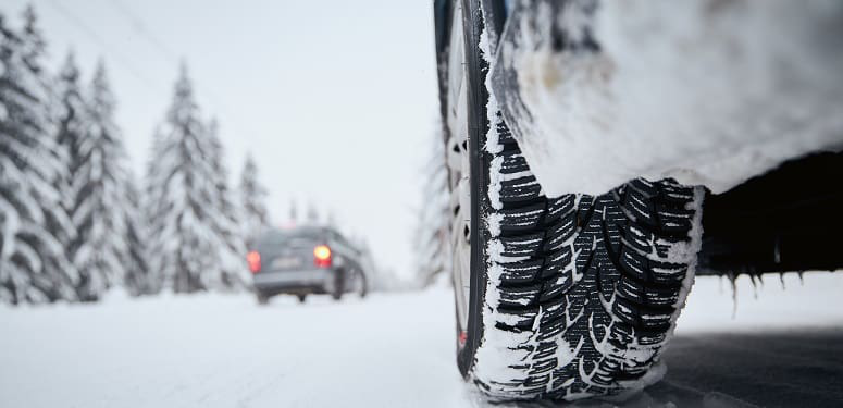 Tire of car on snow covered and icy road