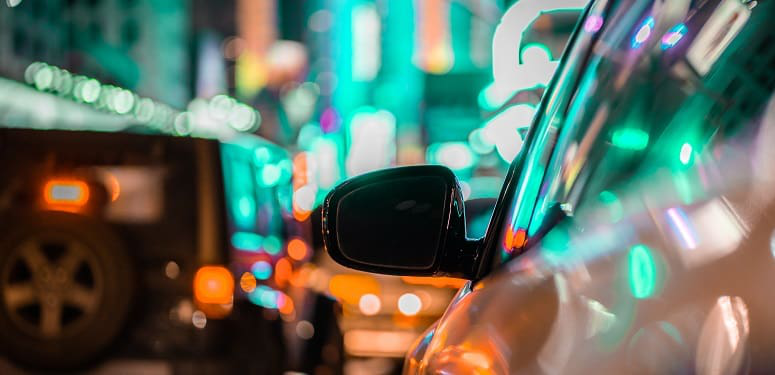 car-and-rear-view-mirror-in-city-traffic-with-ligh-2022-11-04-06-42-28-utc