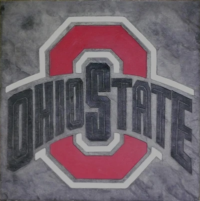 A custom stamped logo showcases how decorative concrete can seamlessly blend branding and design.