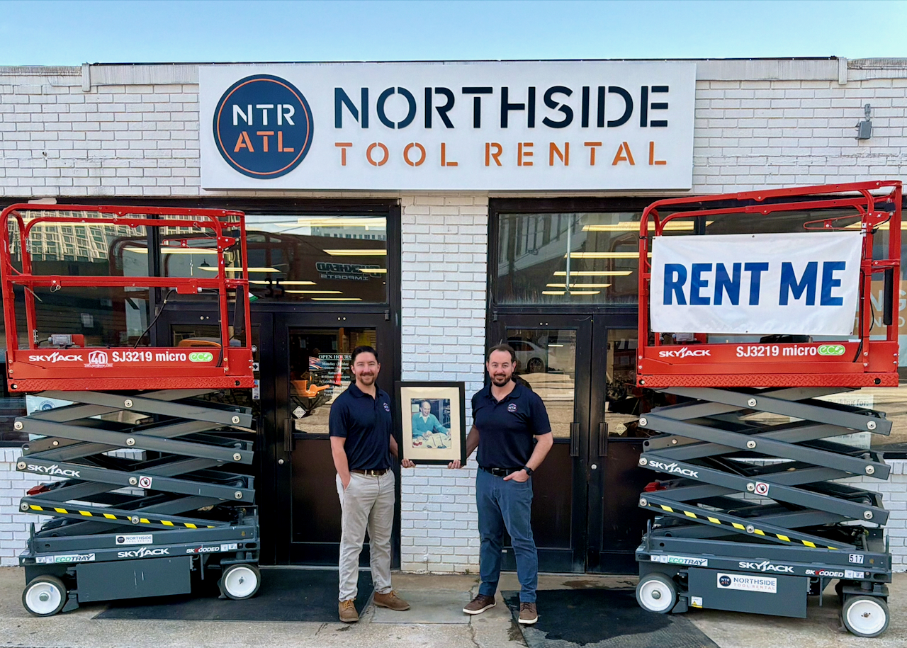 Three families coming back together. Josh Nickell (at right) and Cooper Douville (at left) celebrating the acquisition in their Buckhead branch, holding a picture of the Northside Tool Rental founder Roy Milling. Fun fact: Cooper and Josh's dad were coworkers and mentored by Roy.