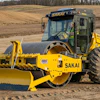 The pictured SV544-1 variant is a padfoot model (SV544T-1) with the following factory-installed optional equipment: bolt-through design smooth shell kit, enclosed cab, and hydraulic leveling blade.