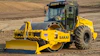 The pictured SV544-1 variant is a padfoot model (SV544T-1) with the following factory-installed optional equipment: bolt-through design smooth shell kit, enclosed cab, and hydraulic leveling blade.