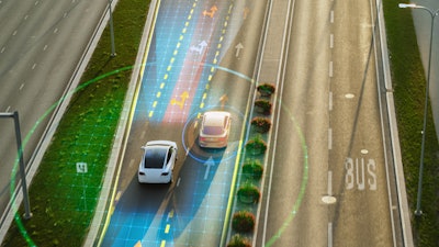 Autonomous vehicles with digital sensor visualization on multi-lane highway.