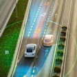 Autonomous vehicles with digital sensor visualization on multi-lane highway.
