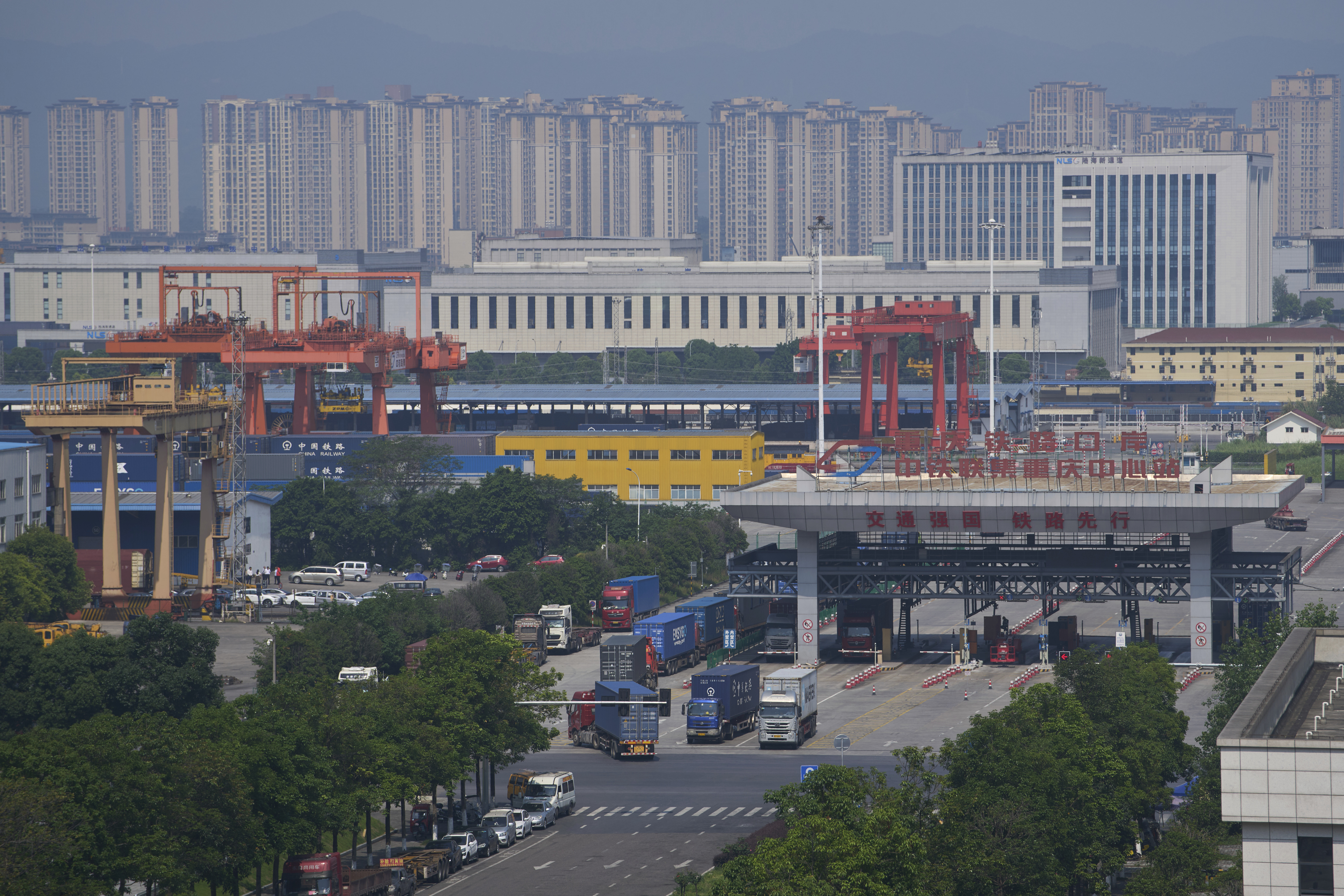 Trucks leave the Chongqing Railway Container Terminal Station after loading their containers, in southwest China's Chongqing Municipality on Tuesday, May 20, 2025.