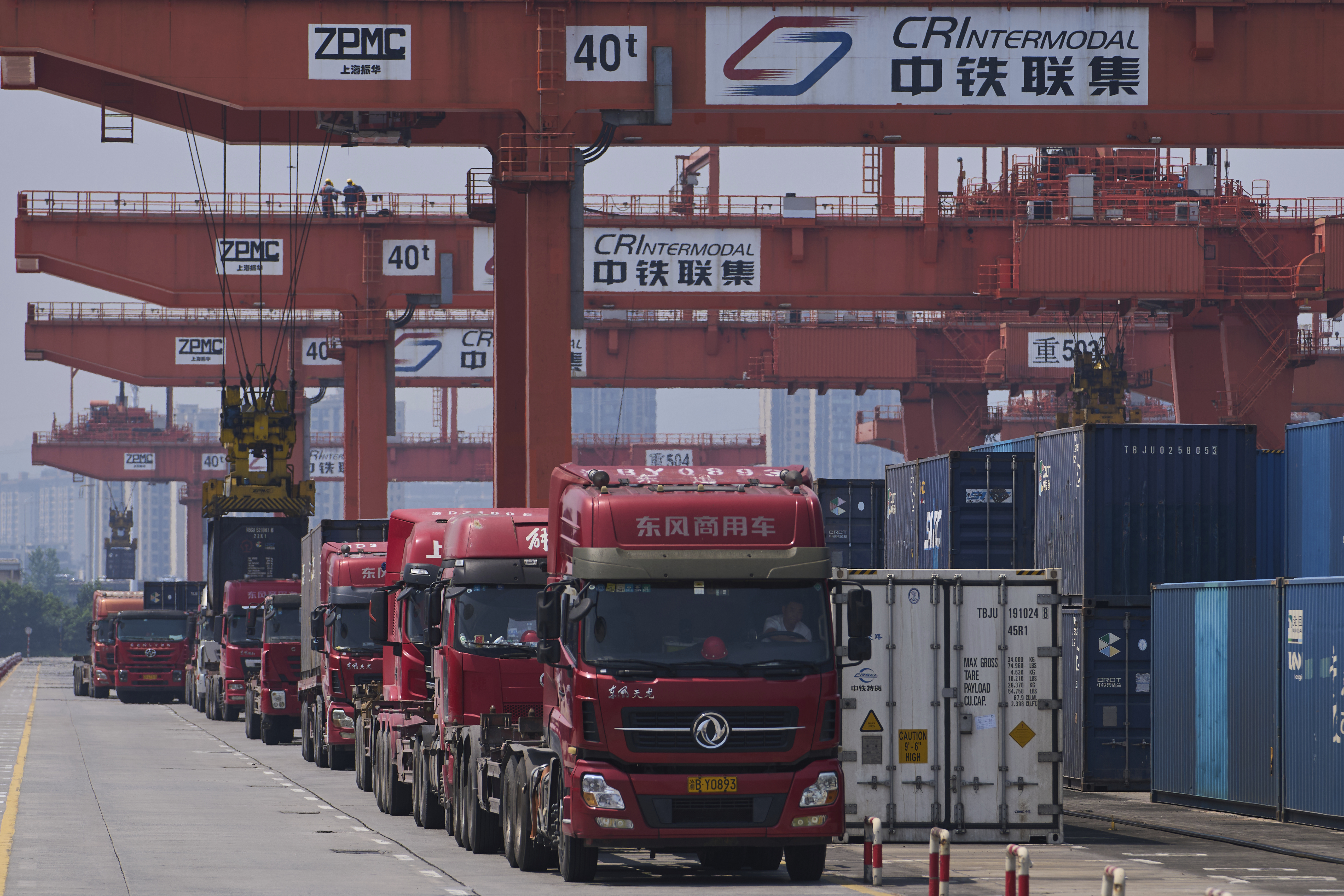 Machines load containers to the trucks at the Chongqing Railway Container Terminal Station, in southwest China's Chongqing Municipality on Tuesday, May 20, 2025.