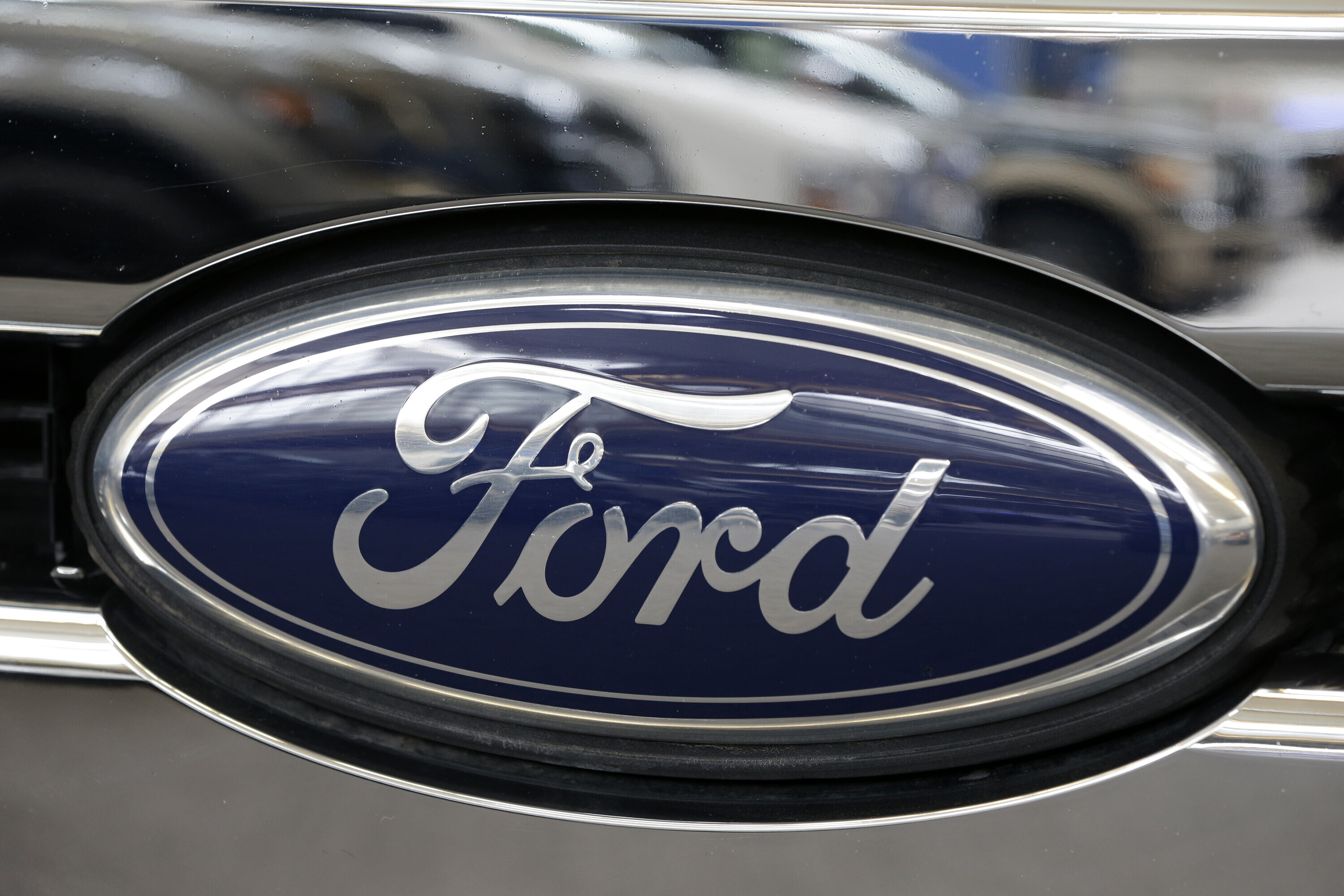 This Photo taken Feb. 14, 2013 shows a Ford logo at the 2013 Pittsburgh Auto Show in Pittsburgh.