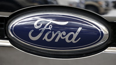 This Photo taken Feb. 14, 2013 shows a Ford logo at the 2013 Pittsburgh Auto Show in Pittsburgh.