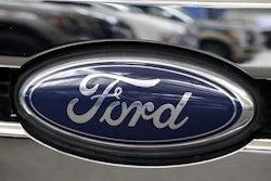 This Photo taken Feb. 14, 2013 shows a Ford logo at the 2013 Pittsburgh Auto Show in Pittsburgh.