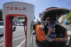 Janelle Lowe prepares to charge her electric vehicle at a station May 22, 2025, in Long Beach, Calif.