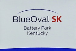 Logos for BlueOval SK and Ford are displayed on a podium during a celebration for the progress of the BlueOval SK Battery Park in Glendale, Ky., Dec. 5, 2022.