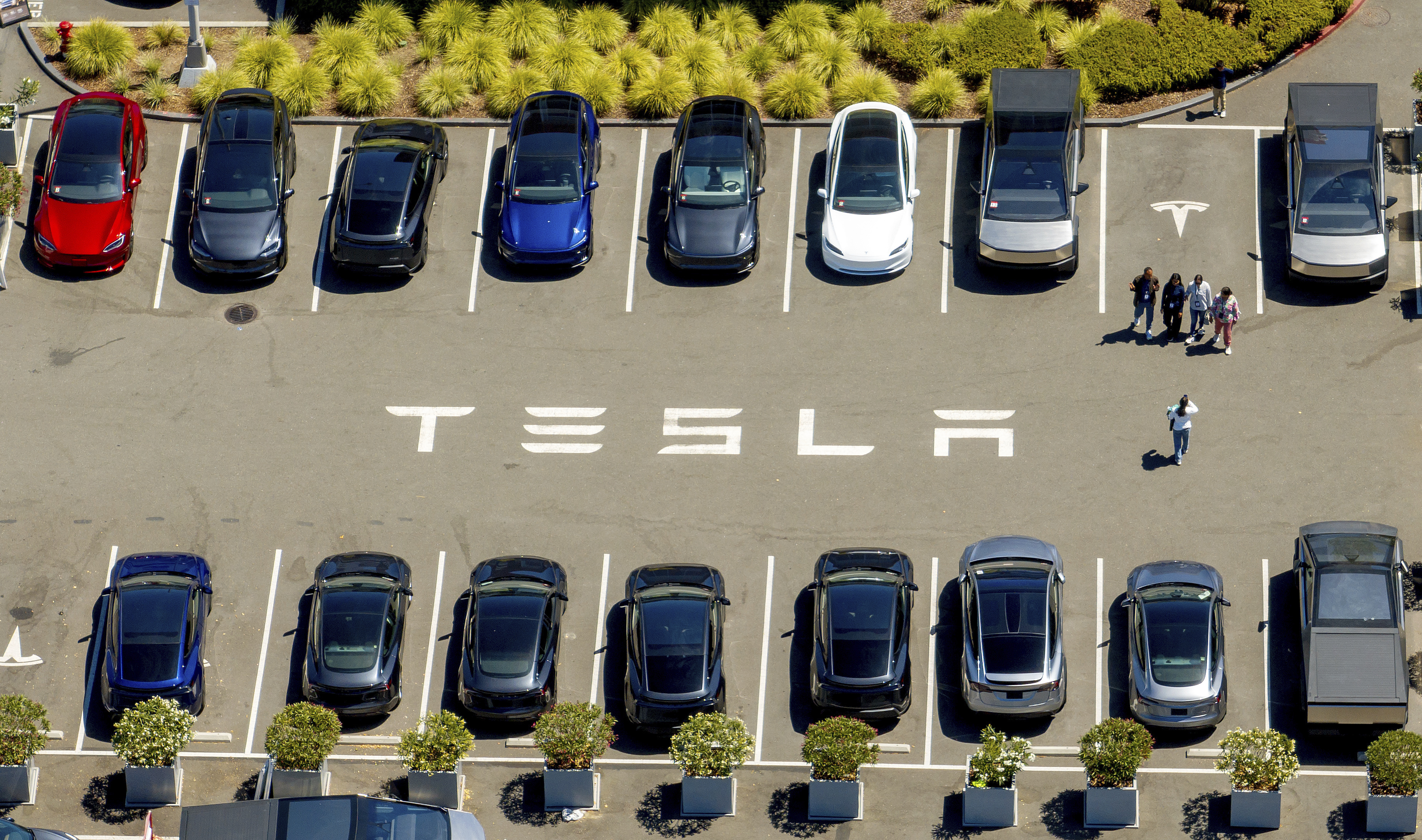 Tesla vehicles line a parking area at the company's Fremont, Calif., factory on Tuesday, Aug. 5, 2025.