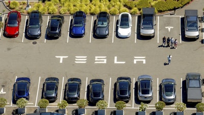 Tesla vehicles line a parking area at the company's Fremont, Calif., factory on Tuesday, Aug. 5, 2025.