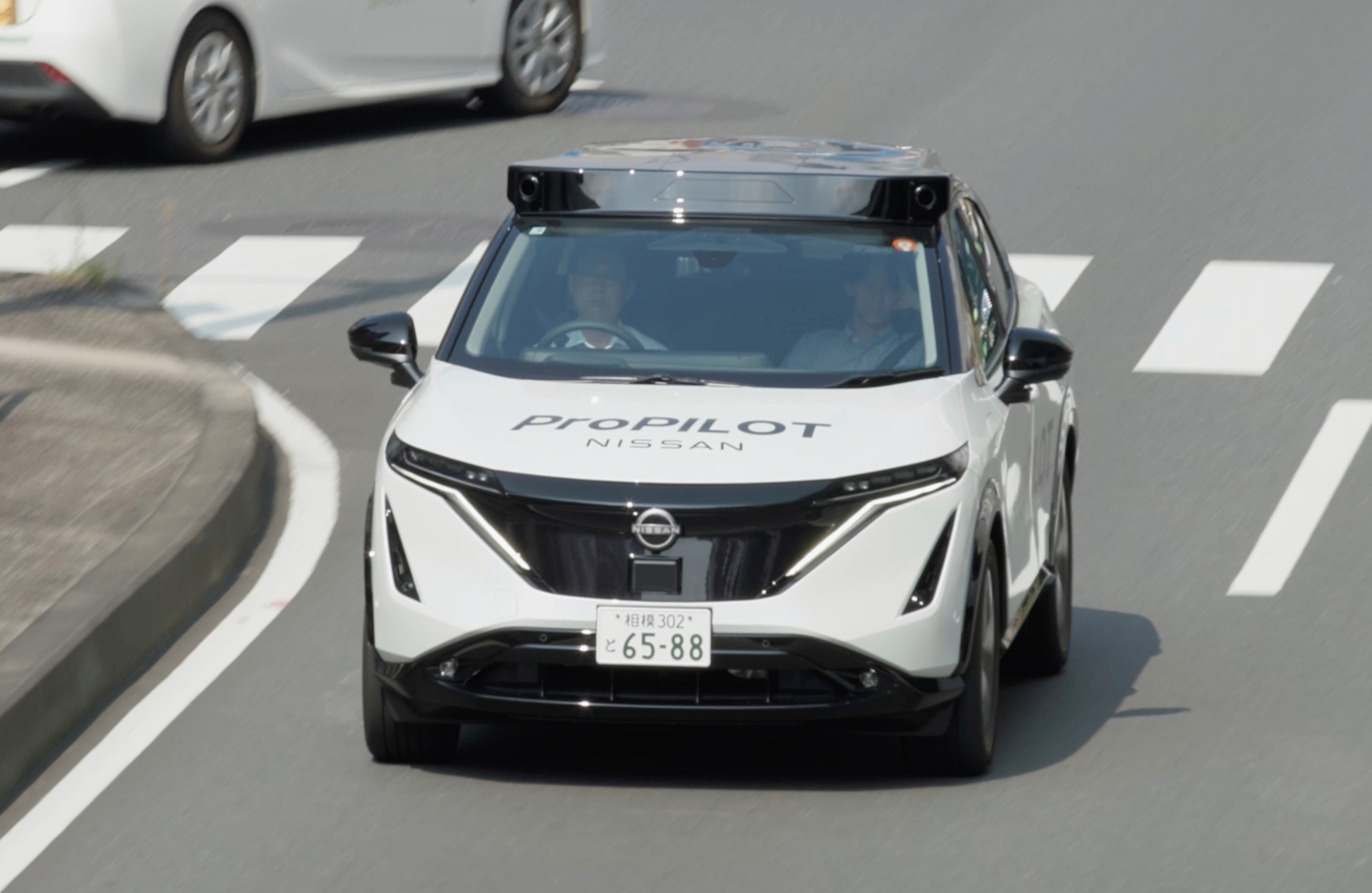 In this image made from video provided by Nissan Motor Co., Japanese automaker Nissan's test vehicle featuring an automated driving system packed with artificial intelligence moves on a road in Tokyo on September, 2025.