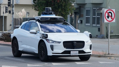 A Waymo vehicle drives past a No U-Turn sign in San Bruno, Calif., Tuesday, Sept. 30, 2025.