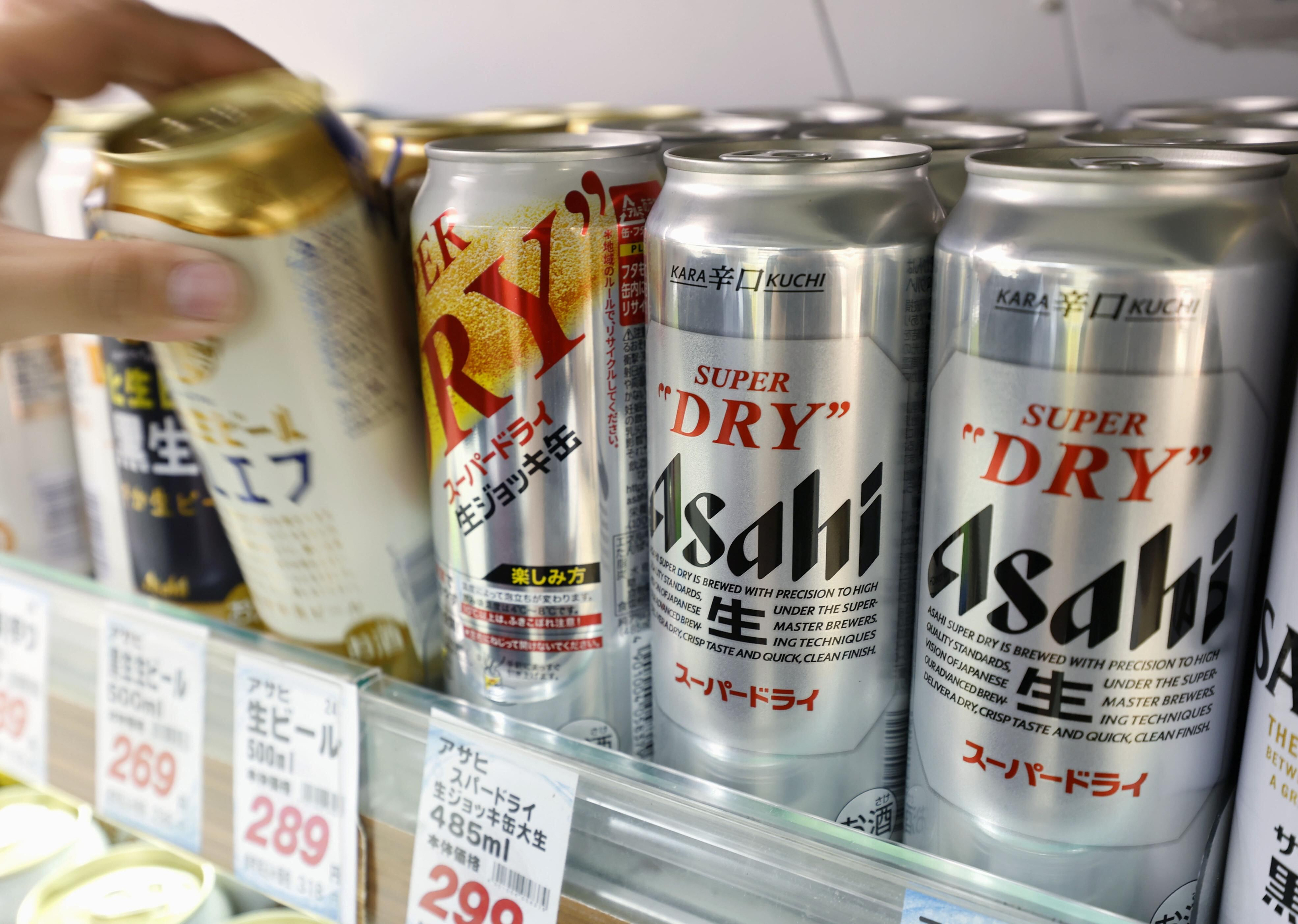 Cans of beer sit on a shelf at a supermarket in Yokohama, near Tokyo Friday, Oct. 3, 2025.