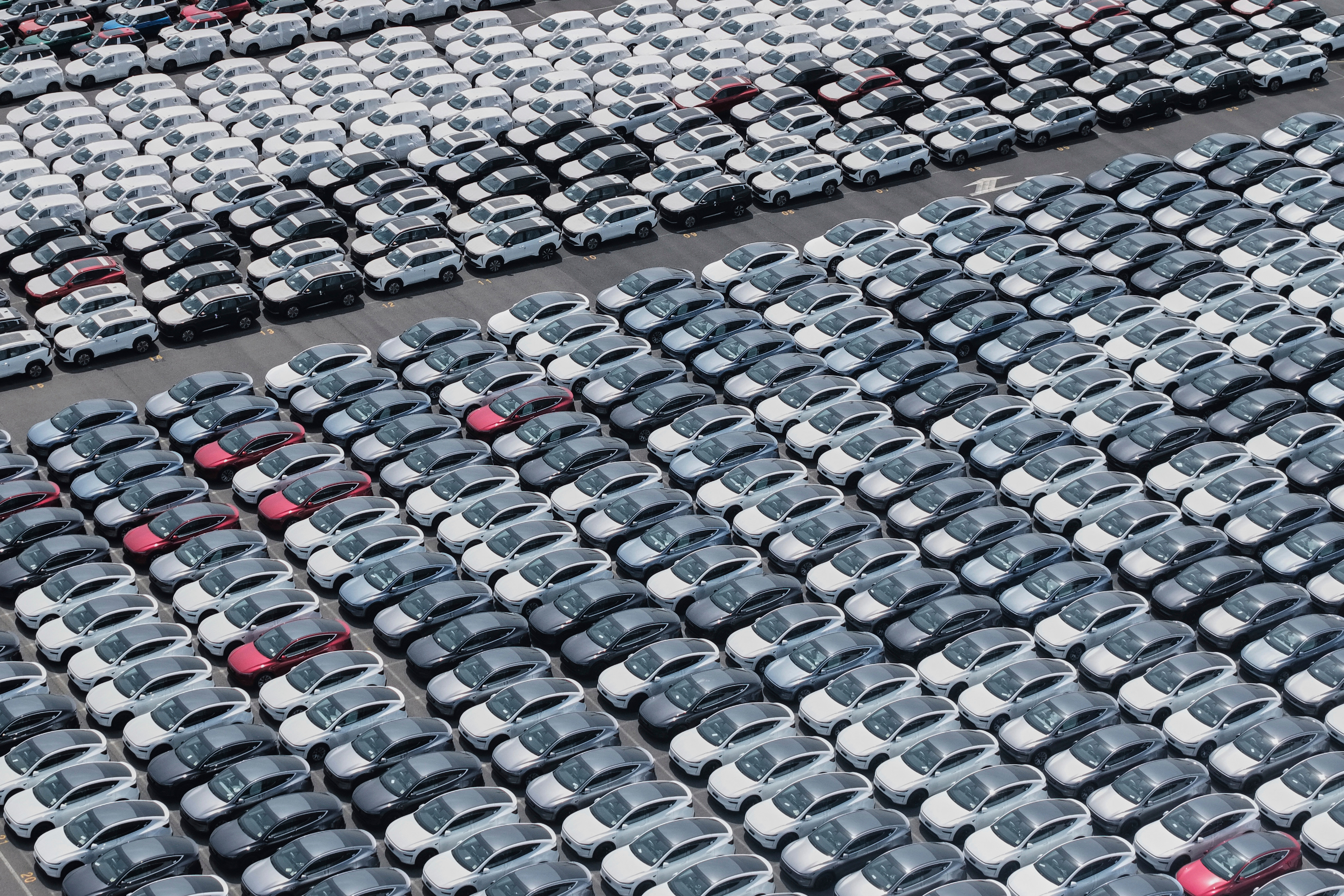 New cars for export wait for shipment at a port in Shanghai, China on May 11, 2025.