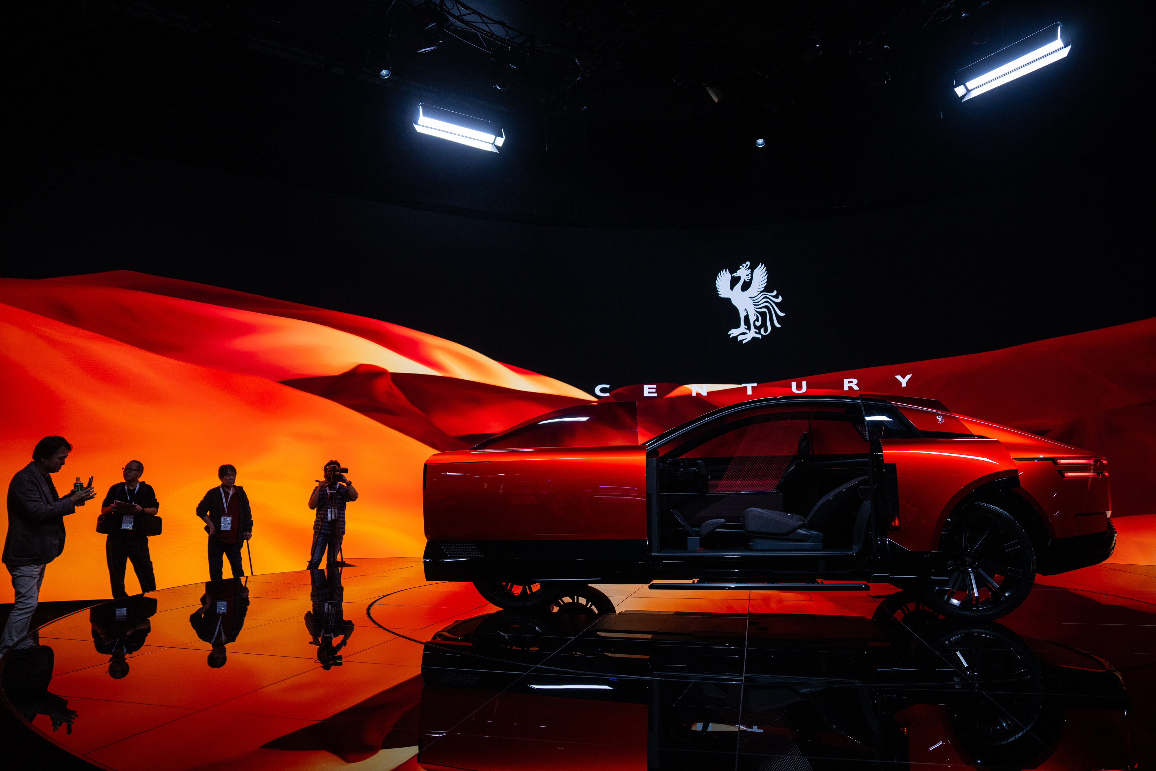 Members of the media and guests look at a Century's concept model during the press day of the Japan Mobility Show, in Tokyo, Thursday, Oct. 30, 2025.