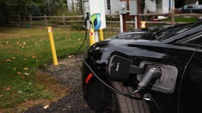 Daphne Dixon's electric vehicle is plugged into a Level 2 EV charger Saturday, Oct. 11, 2025, in Norwalk, Conn.