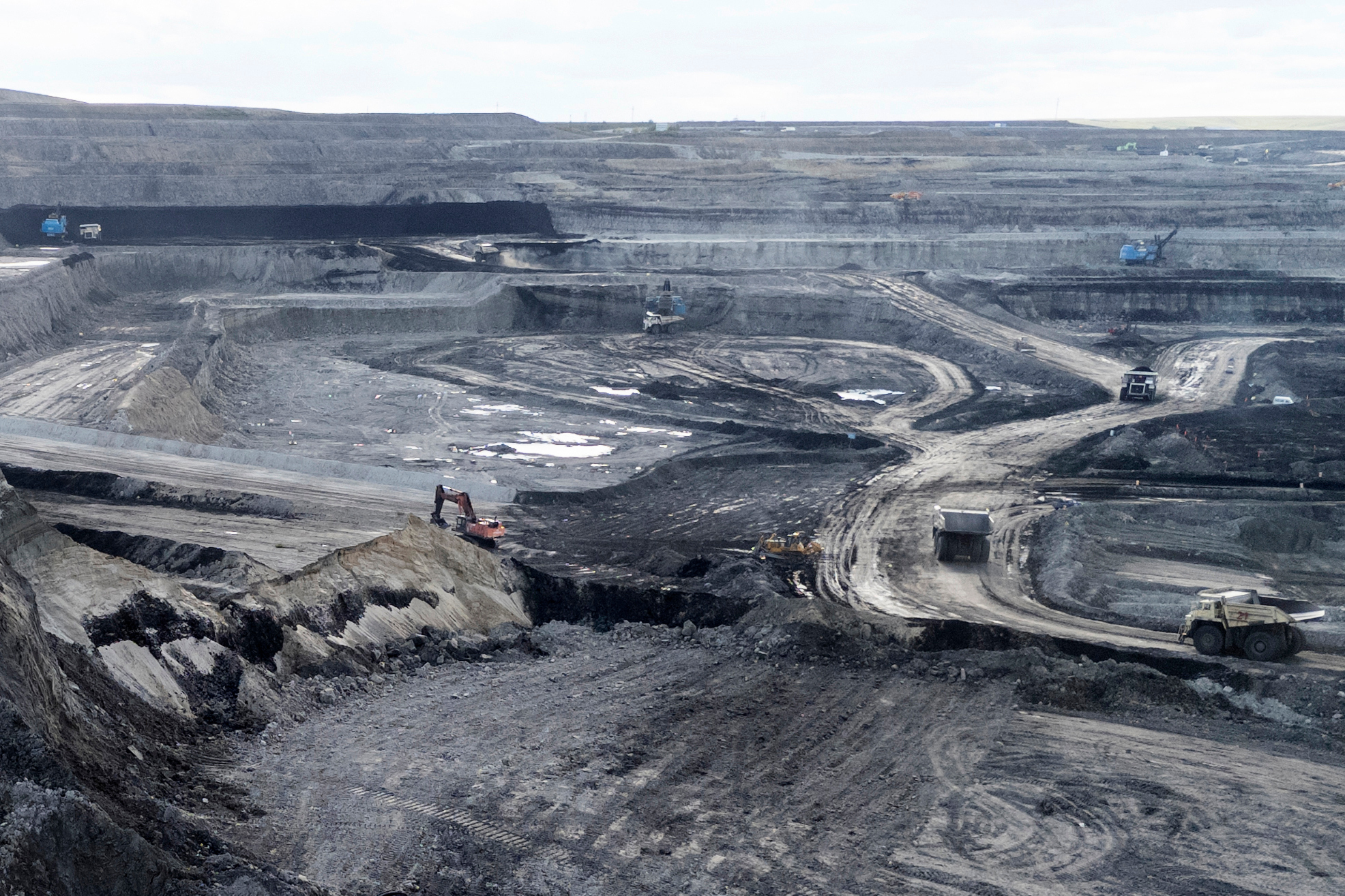Traditional mining trucks can be seen at the Huaneng Yimin open-pit coal mine in Hulunbuir in northern China's Inner Mongolia province China, Monday, Sept. 15, 2025.