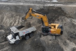 An excavator loads an autonomous mining truck in the Huaneng Yimin open-pit coal mine in Hulunbuir in northern China's Inner Mongolia province China, Monday, Sept. 15, 2025.