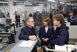Britain's Prime Minister Keir Starmer, left, talks with a student, next to Britain's Chancellor of the Exchequer, Rachel Reeves, center, at the engineering workshop at Coleg Menai.