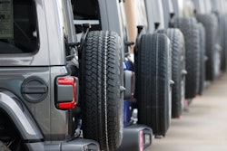 Spare tires are seen on a long row of unsold 2020 Wranglers sit at a Jeep dealership in Englewood, Colo., on April 26, 2020.