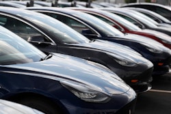 Several 2018 Model 3 sedans sit on display outside a Tesla showroom, July 8, 2018, in Littleton, Colo.
