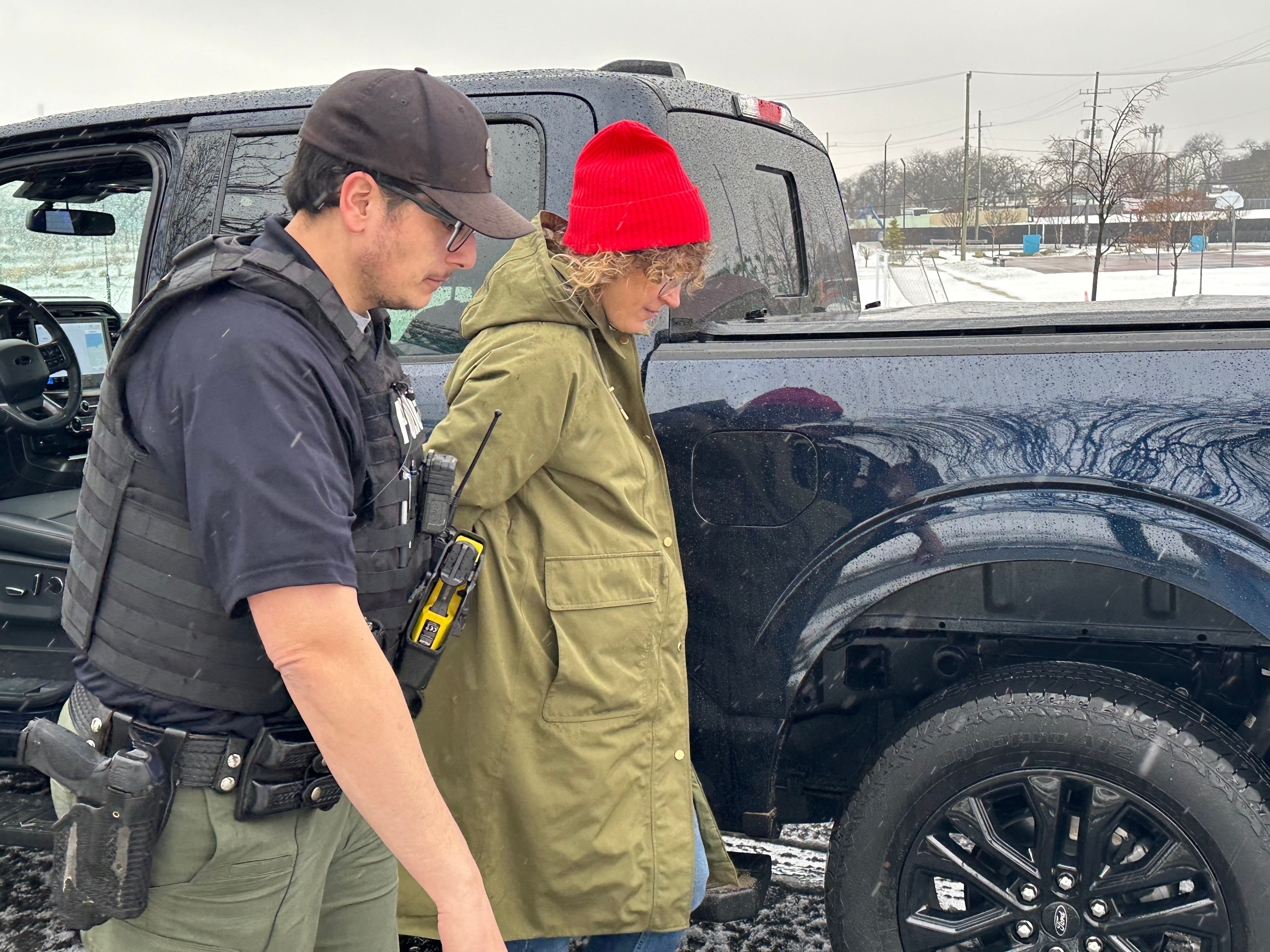 Detroit Police Commercial Theft Section Officer Ibrahim Kakish takes a Ford employee into mock custody during a demonstration Wednesday of how the automaker is using technology to fight thefts of its F-150 pickups and F-250 Super Duty pickups on Wednesday, Dec. 10, 2025.