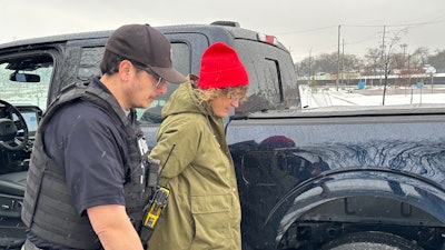 Detroit Police Commercial Theft Section Officer Ibrahim Kakish takes a Ford employee into mock custody during a demonstration Wednesday of how the automaker is using technology to fight thefts of its F-150 pickups and F-250 Super Duty pickups on Wednesday, Dec. 10, 2025.