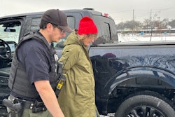 Detroit Police Commercial Theft Section Officer Ibrahim Kakish takes a Ford employee into mock custody during a demonstration Wednesday of how the automaker is using technology to fight thefts of its F-150 pickups and F-250 Super Duty pickups on Wednesday, Dec. 10, 2025.