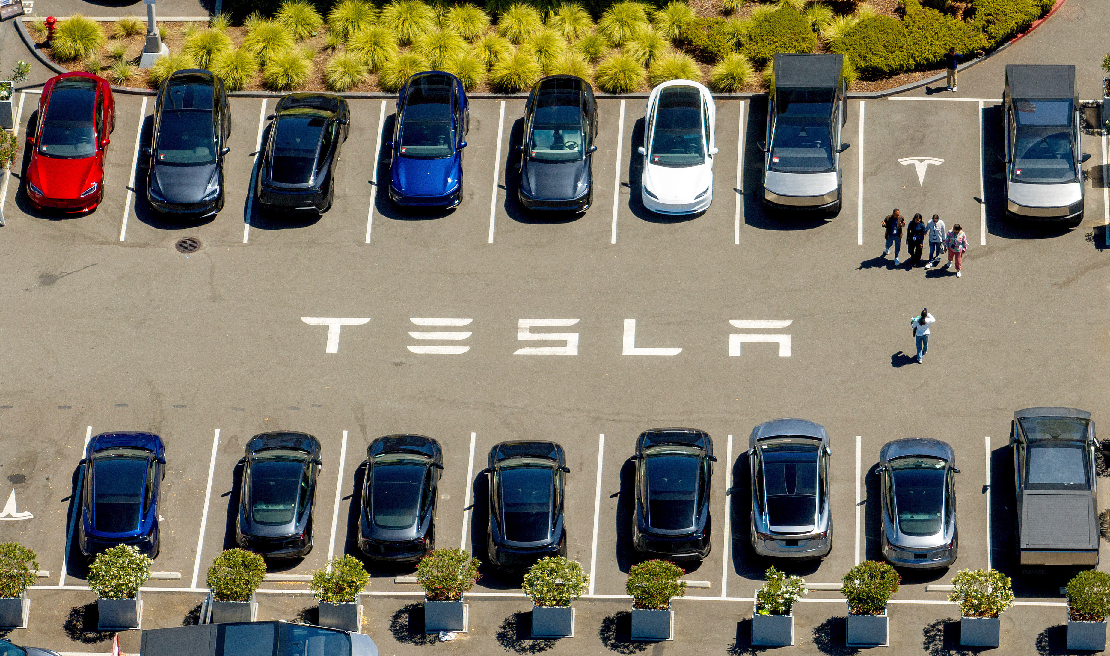 Tesla vehicles line a parking lot at the company's Fremont, Calif., factory on Aug. 5, 2025.