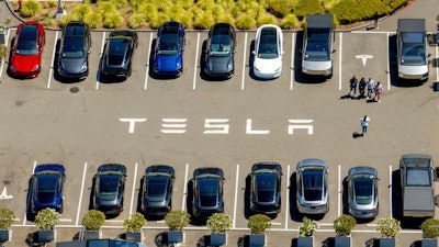 Tesla vehicles line a parking lot at the company's Fremont, Calif., factory on Aug. 5, 2025.
